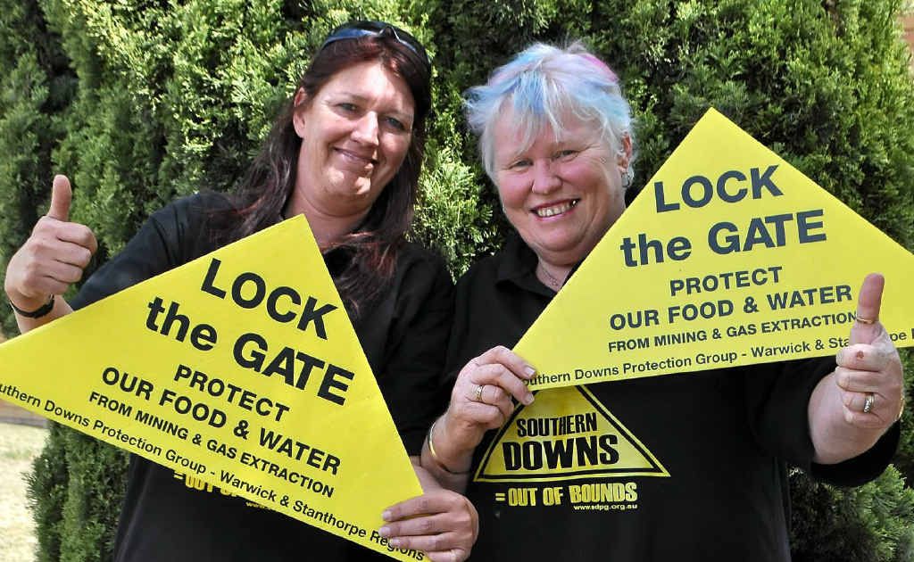 Southern Downs Protection Group president Dawn Heath and committee member Marianne Irvine celebrate Arrow Energy handing its permit back.